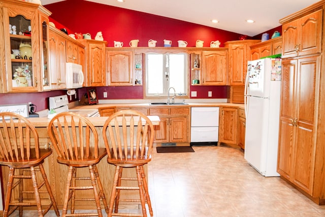 46377 Sunset Ct, Morris, MN 56267 - kitchen with vaulted ceiling, white appliances, a peninsula, light countertops, and a sink