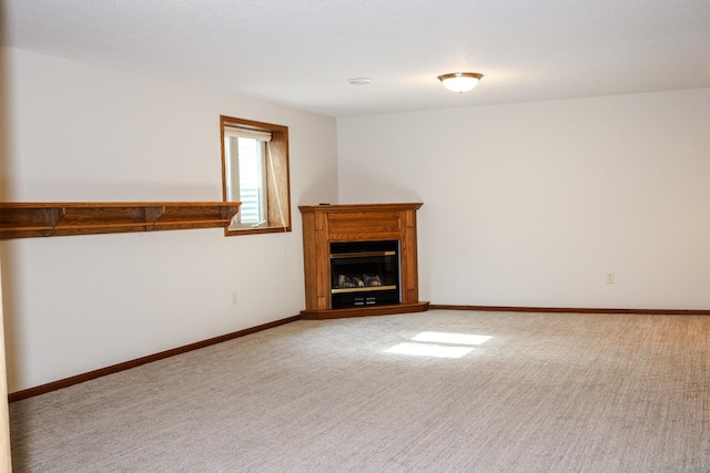 46377 Sunset Ct, Morris, MN 56267 - unfurnished living room featuring light carpet, a glass covered fireplace, and baseboards