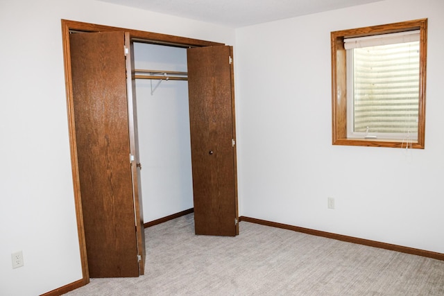 46377 Sunset Ct, Morris, MN 56267 - unfurnished bedroom featuring a closet, baseboards, and carpet