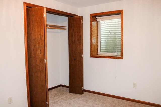 46377 Sunset Ct, Morris, MN 56267 - unfurnished bedroom with a closet, light colored carpet, and baseboards