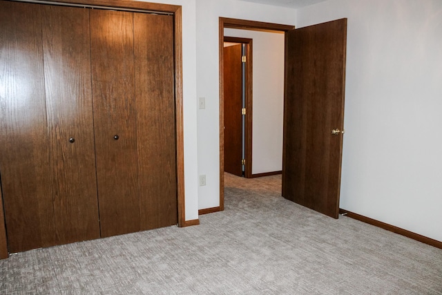 46377 Sunset Ct, Morris, MN 56267 - unfurnished bedroom with a closet, baseboards, and carpet