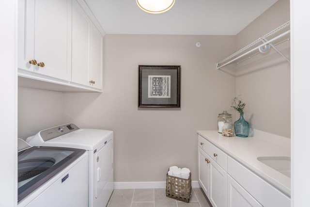 2315 Simply Living Ln Unit C, Hudson, WI 54016 - laundry area with washer and clothes dryer, cabinet space, and light tile patterned flooring