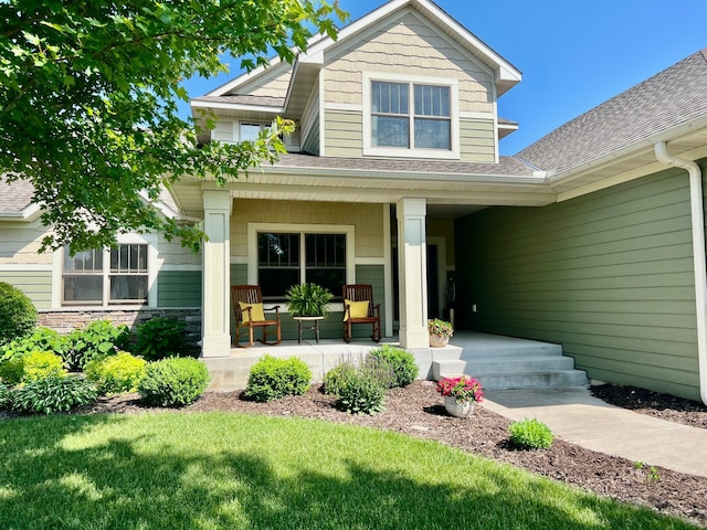 8871 Kahl Way NE, Otsego, MN 55362 - entrance to property featuring a porch, roof with shingles, and a lawn