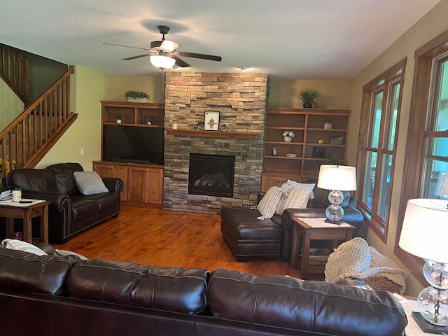 8871 Kahl Way NE, Otsego, MN 55362 - living area featuring a ceiling fan, wood finished floors, stairs, and a fireplace