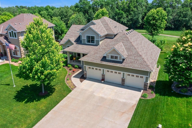 8871 Kahl Way NE, Otsego, MN 55362 - view of front of property featuring stone siding, a front lawn, driveway, and roof with shingles