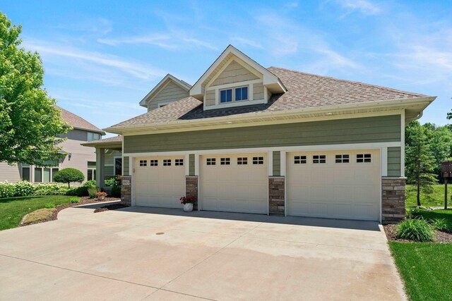 8871 Kahl Way NE, Otsego, MN 55362 - view of front of home with a garage, driveway, a shingled roof, and stone siding
