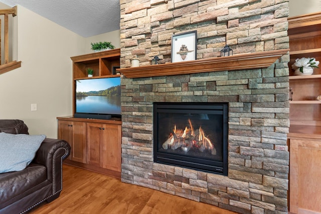 8871 Kahl Way NE, Otsego, MN 55362 - living area featuring light wood-style floors, a textured ceiling, and a fireplace