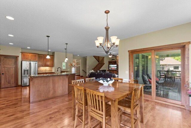 8871 Kahl Way NE, Otsego, MN 55362 - dining room featuring light wood-type flooring, stairway, a chandelier, and recessed lighting