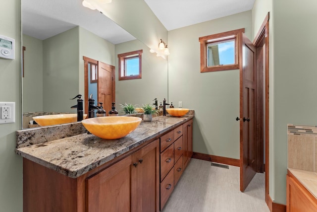 8871 Kahl Way NE, Otsego, MN 55362 - bathroom with double vanity and baseboards