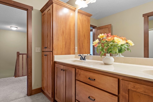 8871 Kahl Way NE, Otsego, MN 55362 - full bath with double vanity, a textured ceiling, and tile patterned flooring