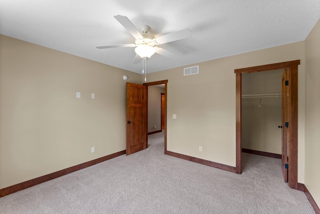 8871 Kahl Way NE, Otsego, MN 55362 - unfurnished bedroom with light carpet, a spacious closet, a closet, and a ceiling fan