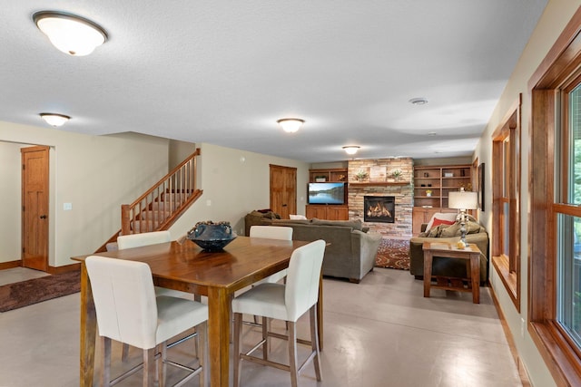 8871 Kahl Way NE, Otsego, MN 55362 - dining area with stairway, built in features, and a fireplace
