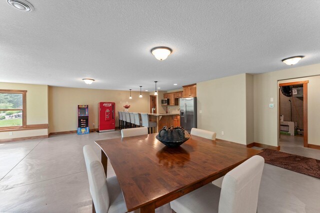 8871 Kahl Way NE, Otsego, MN 55362 - dining area featuring finished concrete floors and a textured ceiling
