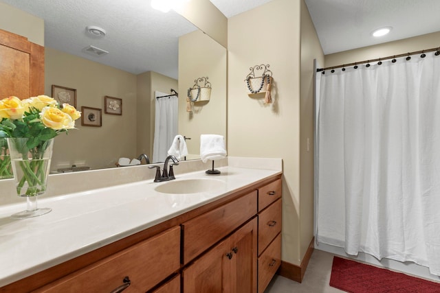 8871 Kahl Way NE, Otsego, MN 55362 - bathroom featuring vanity, curtained shower, and a textured ceiling