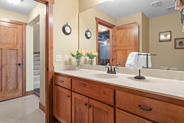 8871 Kahl Way NE, Otsego, MN 55362 - bathroom featuring vanity, finished concrete flooring, and a textured ceiling