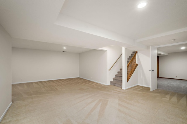 finished basement with baseboards, recessed lighting, light carpet, and stairway