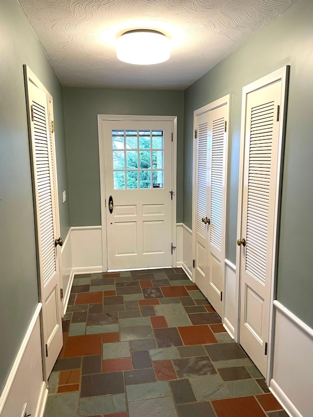 doorway with a textured ceiling