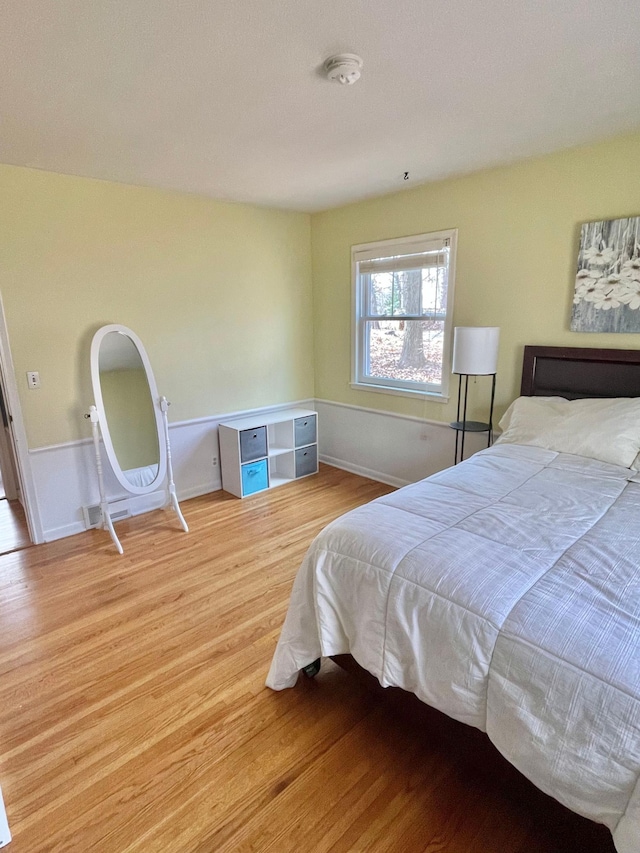 bedroom with baseboards and wood finished floors