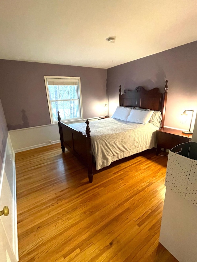 bedroom featuring baseboards and wood finished floors