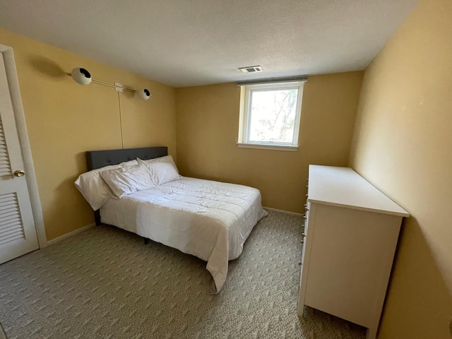 carpeted bedroom with a textured ceiling, visible vents, and baseboards