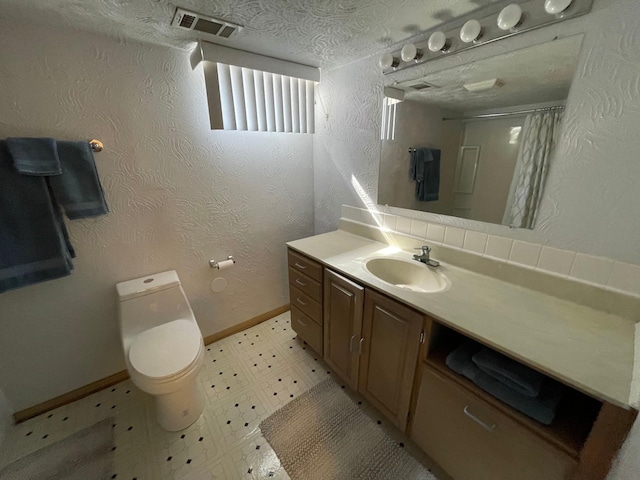 bathroom featuring vanity, baseboards, tile patterned floors, toilet, and visible vents