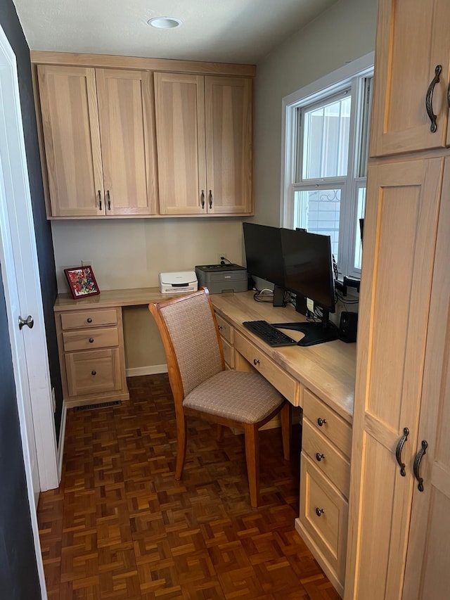 home office featuring built in desk and baseboards