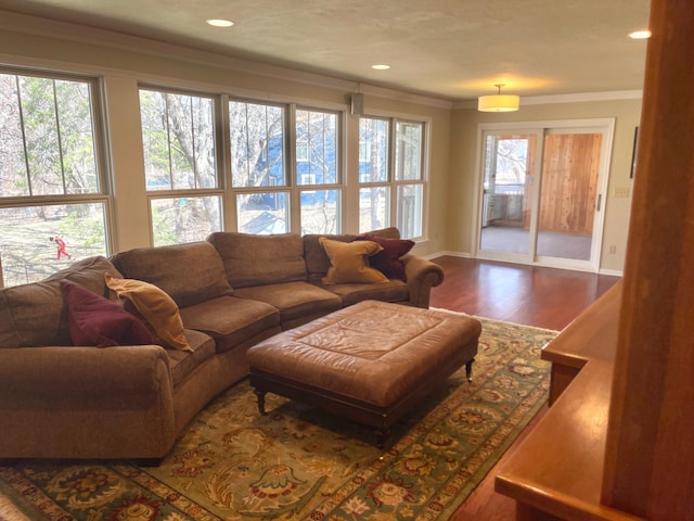 living room with ornamental molding, recessed lighting, plenty of natural light, and wood finished floors