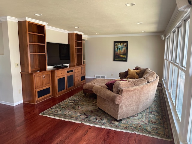 living area with a healthy amount of sunlight, visible vents, baseboards, and dark wood finished floors
