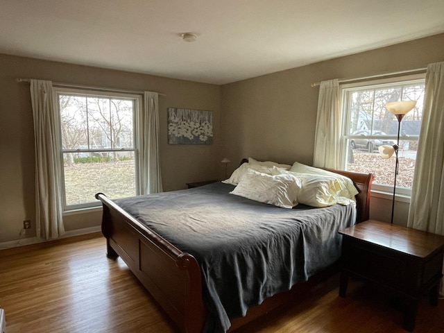 bedroom featuring baseboards and wood finished floors
