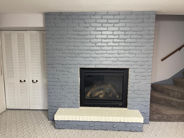 room details featuring a fireplace and carpet