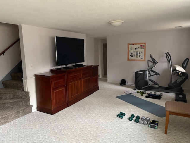 workout room featuring carpet flooring and baseboards