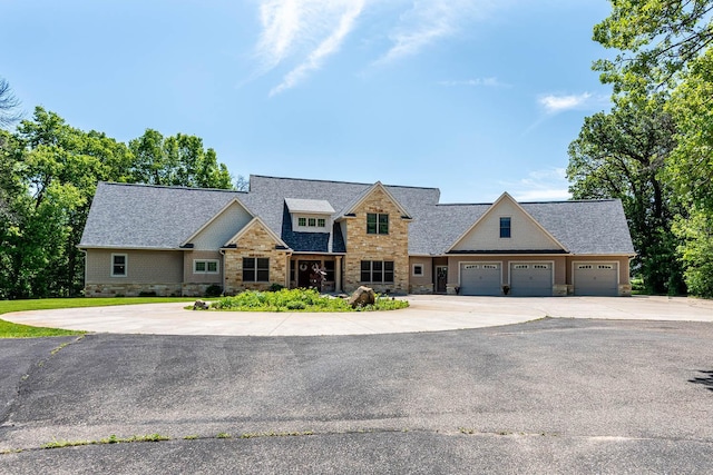 190 Stony Creek Rd, Mankato, MN 56001 - view of front of home with stone siding, concrete driveway, an attached garage, and a shingled roof