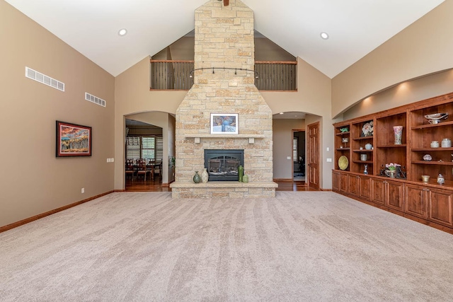 190 Stony Creek Rd, Mankato, MN 56001 - unfurnished living room with carpet flooring, high vaulted ceiling, a fireplace, baseboards, and arched walkways