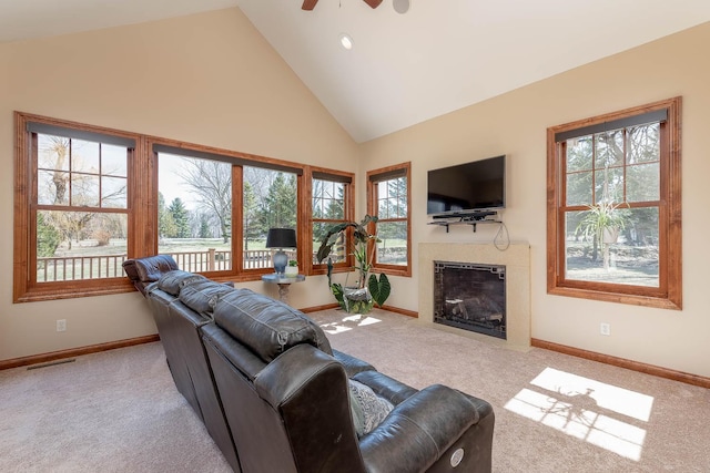 190 Stony Creek Rd, Mankato, MN 56001 - carpeted living room with high vaulted ceiling, plenty of natural light, baseboards, a fireplace, and a ceiling fan