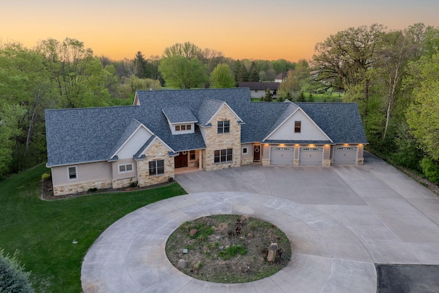 190 Stony Creek Rd, Mankato, MN 56001 - craftsman inspired home with stone siding, curved driveway, a front yard, an attached garage, and roof with shingles