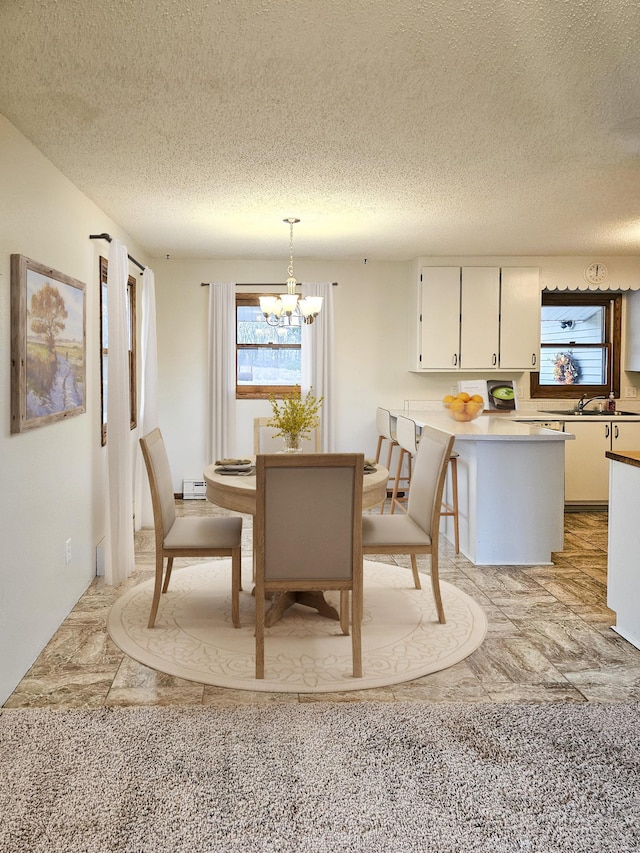 14199 Riverbend Trl, Rocksbury Twp, MN 56701 - dining space with a textured ceiling and a chandelier