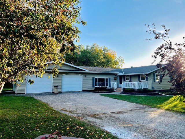 14199 Riverbend Trl, Rocksbury Twp, MN 56701 - single story home with decorative driveway, covered porch, a garage, and a front lawn