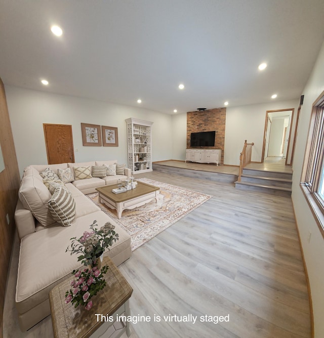 14199 Riverbend Trl, Rocksbury Twp, MN 56701 - living area with wood finished floors, a fireplace, recessed lighting, and stairway