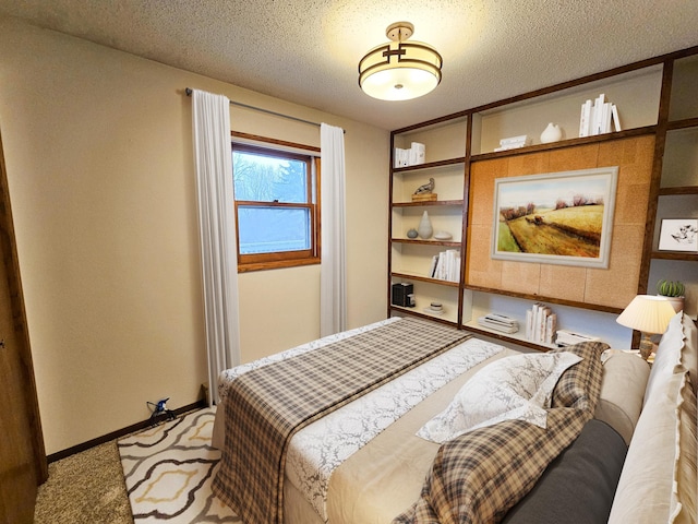 14199 Riverbend Trl, Rocksbury Twp, MN 56701 - carpeted bedroom with baseboards and a textured ceiling