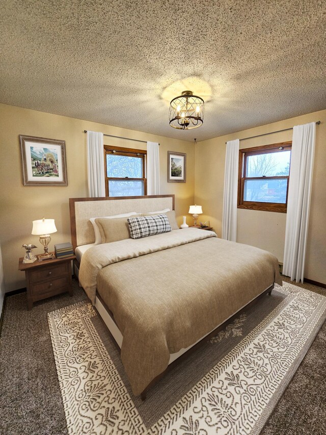 14199 Riverbend Trl, Rocksbury Twp, MN 56701 - carpeted bedroom with a chandelier and a textured ceiling