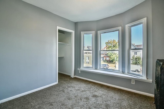 unfurnished bedroom featuring a closet, carpet flooring, and baseboards