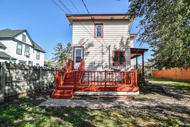 rear view of property featuring fence