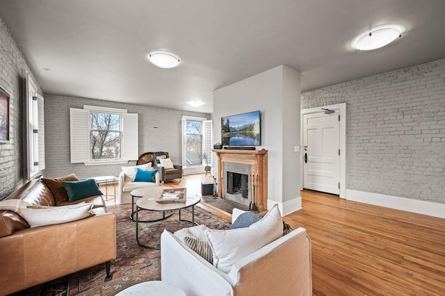 438 Portland Ave Unit 7, Saint Paul, MN 55102 - living room with brick wall, baseboards, wood finished floors, and a high end fireplace
