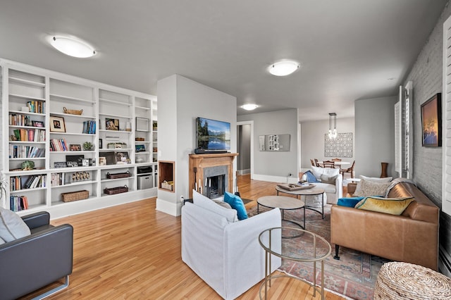 438 Portland Ave Unit 7, Saint Paul, MN 55102 - living room featuring wood finished floors, a high end fireplace, brick wall, and baseboards