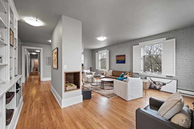 438 Portland Ave Unit 7, Saint Paul, MN 55102 - living area featuring baseboards, light wood-style floors, and a baseboard heating unit