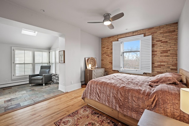 438 Portland Ave Unit 7, Saint Paul, MN 55102 - bedroom featuring wood finished floors, baseboards, ceiling fan, a baseboard radiator, and a baseboard heating unit