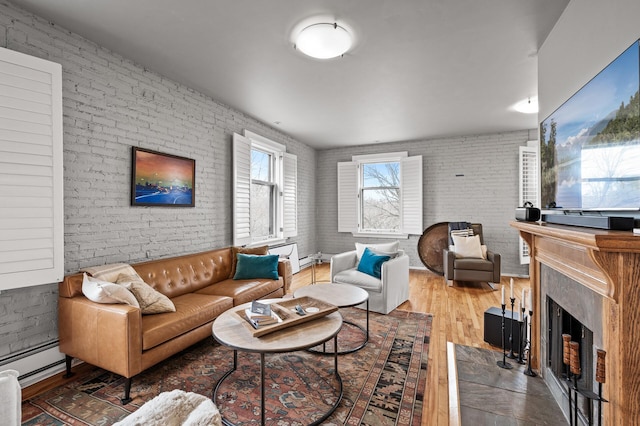 438 Portland Ave Unit 7, Saint Paul, MN 55102 - living area with wood finished floors, a fireplace, brick wall, and a baseboard radiator