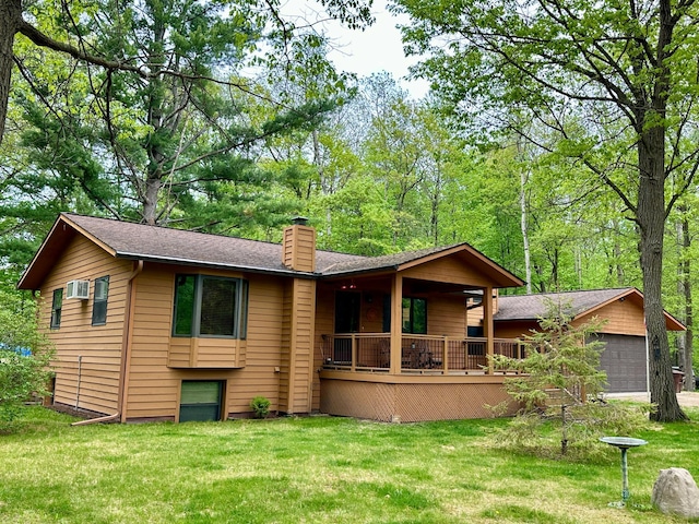 12124 County Road 118, Merrifield, MN 56465 - back of house featuring a chimney, a lawn, a garage, and a shingled roof
