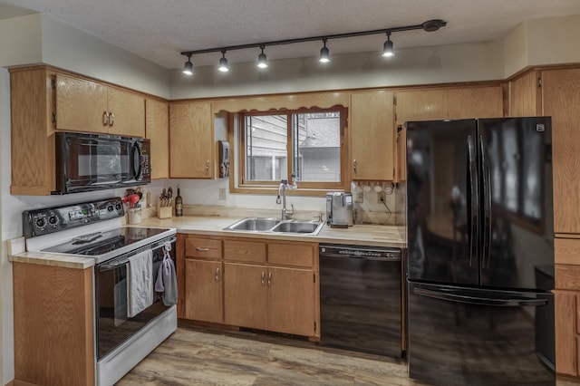 12124 County Road 118, Merrifield, MN 56465 - kitchen featuring black appliances, a sink, light countertops, and light wood-style flooring