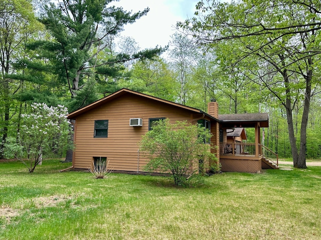 12124 County Road 118, Merrifield, MN 56465 - view of side of property featuring a chimney, a lawn, a wall mounted air conditioner, and a porch